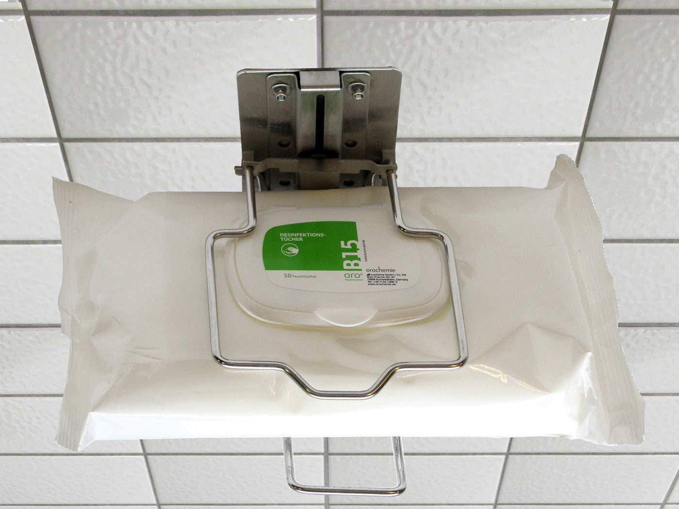 Wall holder for disinfectant wipes in flowpacks